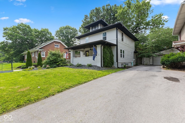 953 E 34th St, Indianapolis, IN 46205 - traditional style home with a front yard, covered porch, brick siding, and an outdoor structure
