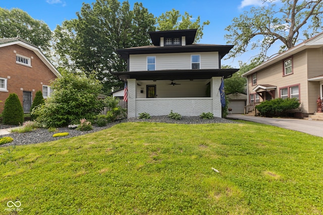 953 E 34th St, Indianapolis, IN 46205 - american foursquare style home featuring a ceiling fan, a front lawn, brick siding, and an outbuilding