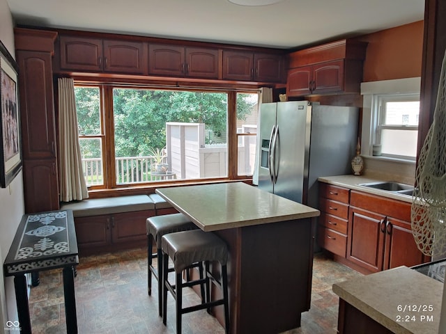121 N Main St, Pendleton, IN 46064 - kitchen featuring stainless steel fridge, light countertops, a center island, and a kitchen breakfast bar