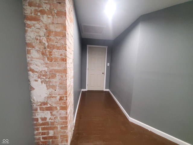 702 W Cross St, Brownstown, IN 47220 - hallway featuring dark wood-style flooring and brick wall