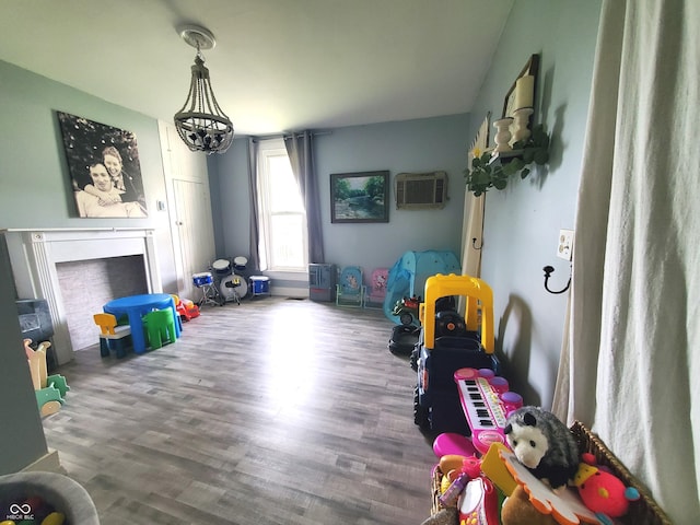 702 W Cross St, Brownstown, IN 47220 - rec room featuring a wall unit AC and wood finished floors