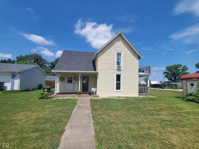 702 W Cross St, Brownstown, IN 47220 - traditional-style house with a front lawn, covered porch, and a shingled roof