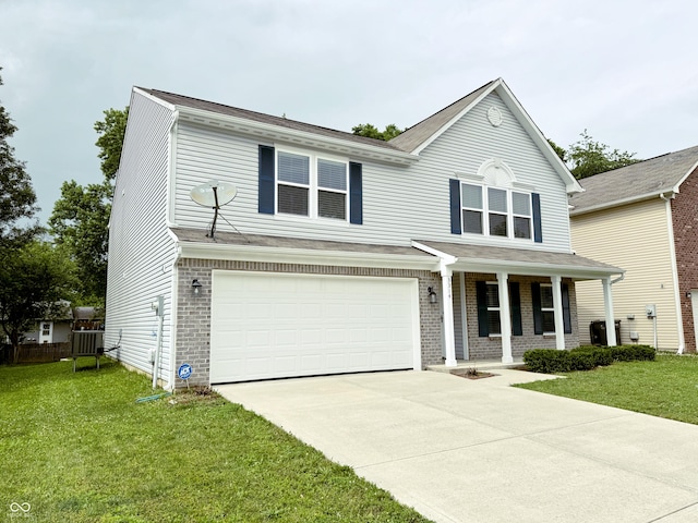 3314 Montgomery Dr, Indianapolis, IN 46227 - view of front facade with a porch, a garage, a front lawn, driveway, and brick siding