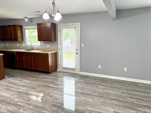 3314 Montgomery Dr, Indianapolis, IN 46227 - kitchen with black dishwasher, wood finished floors, light countertops, pendant lighting, and a chandelier