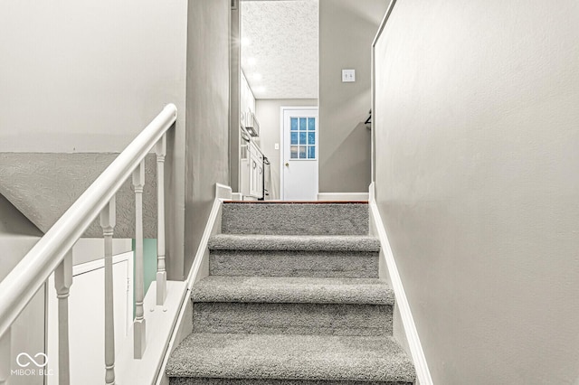 7616 Concord Ln, Fishers, IN 46038 - stairway with a textured ceiling and baseboards
