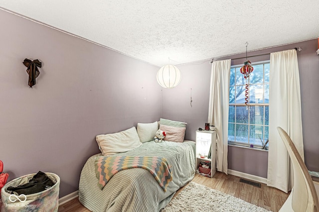 7616 Concord Ln, Fishers, IN 46038 - bedroom featuring wood finished floors and a textured ceiling