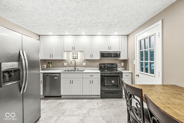 7616 Concord Ln, Fishers, IN 46038 - kitchen with stainless steel appliances, light countertops, a textured ceiling, and recessed lighting