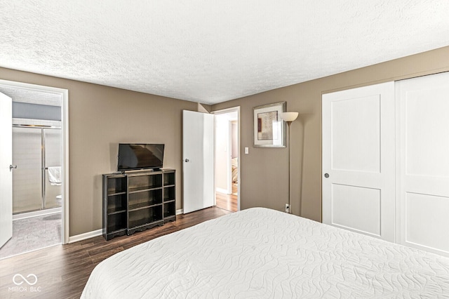 7616 Concord Ln, Fishers, IN 46038 - bedroom featuring dark wood finished floors, a textured ceiling, and ensuite bathroom