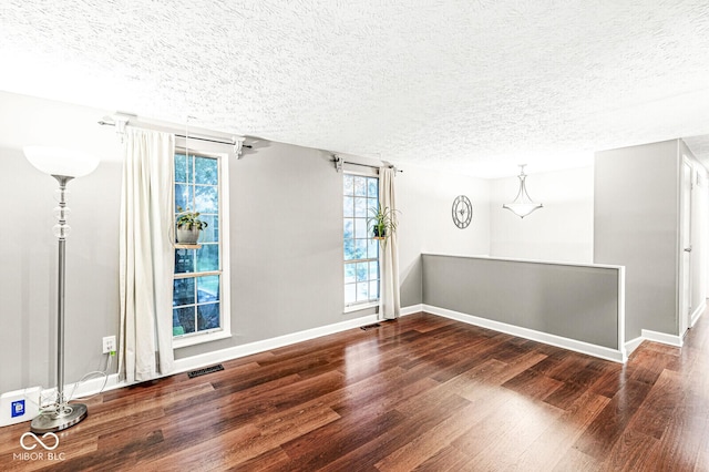7616 Concord Ln, Fishers, IN 46038 - spare room with wood finished floors, a textured ceiling, and healthy amount of natural light