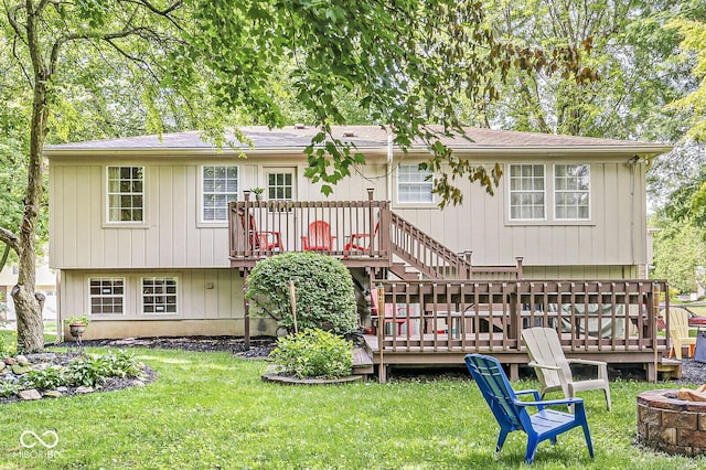 7616 Concord Ln, Fishers, IN 46038 - back of property featuring a fire pit, a deck, and a lawn
