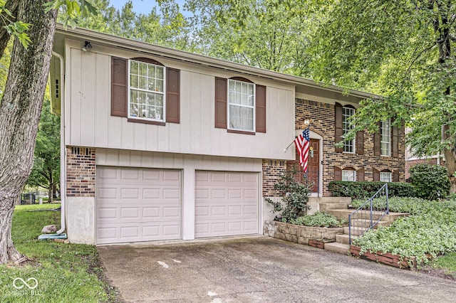 7616 Concord Ln, Fishers, IN 46038 - raised ranch with brick siding, an attached garage, and concrete driveway