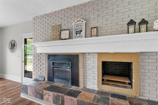 925 W Hancock Rd, Scottsburg, IN 47170 - detailed view of a glass covered fireplace, wood finished floors, and a textured ceiling