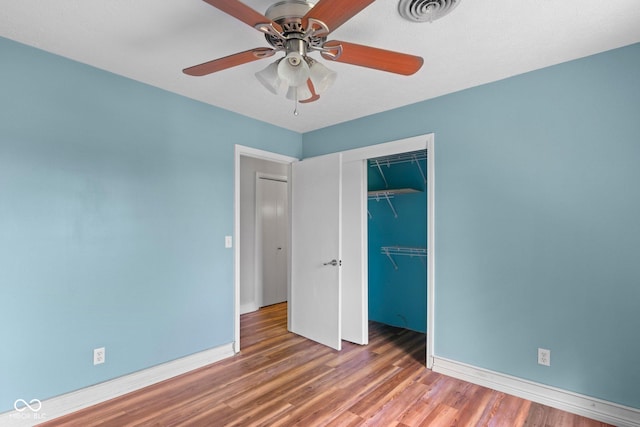 925 W Hancock Rd, Scottsburg, IN 47170 - unfurnished bedroom with wood finished floors, a closet, and ceiling fan