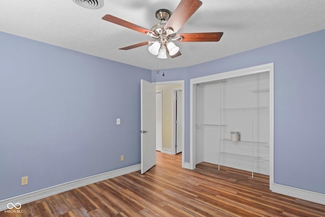 925 W Hancock Rd, Scottsburg, IN 47170 - unfurnished bedroom featuring wood finished floors, a closet, and a ceiling fan