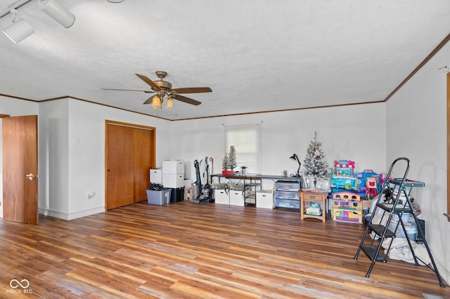 925 W Hancock Rd, Scottsburg, IN 47170 - living area with wood finished floors, a ceiling fan, crown molding, and a textured ceiling