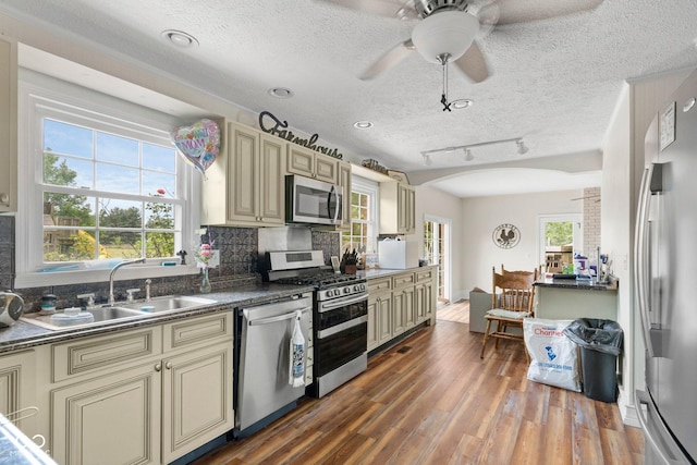 925 W Hancock Rd, Scottsburg, IN 47170 - kitchen with cream cabinets, appliances with stainless steel finishes, arched walkways, dark countertops, and healthy amount of natural light