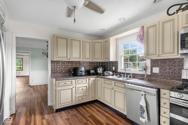 925 W Hancock Rd, Scottsburg, IN 47170 - kitchen with cream cabinetry, appliances with stainless steel finishes, ornamental molding, a ceiling fan, and dark wood finished floors