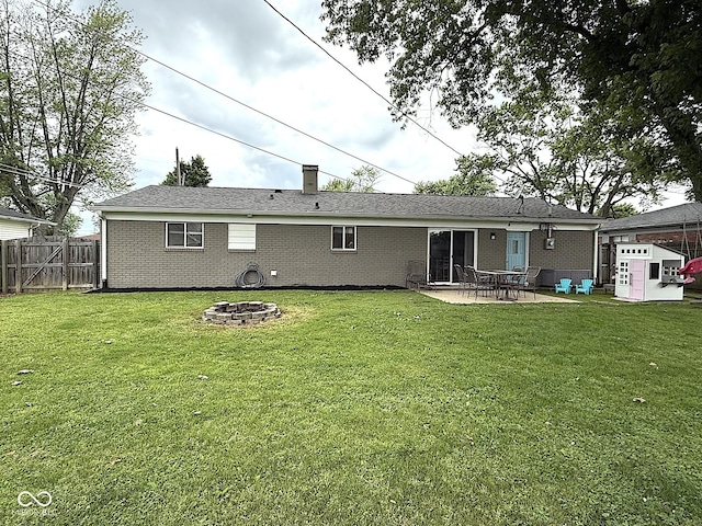 729 Maple Ln, Brownsburg, IN 46112 - rear view of property featuring a fire pit, a patio area, brick siding, and a chimney