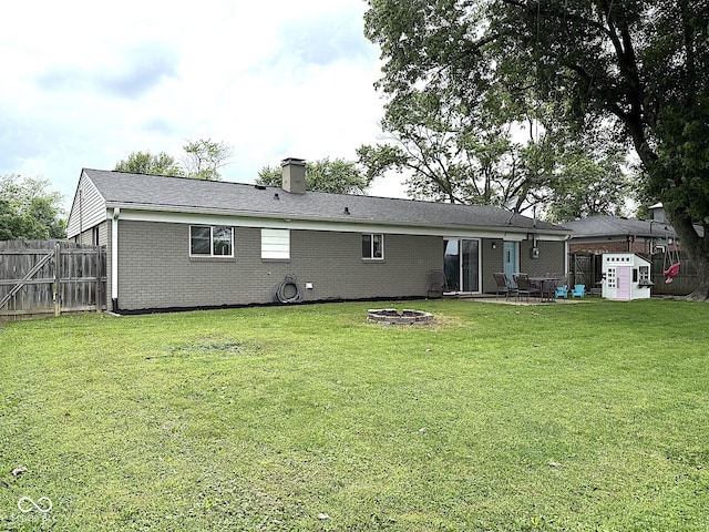 729 Maple Ln, Brownsburg, IN 46112 - back of property with an outdoor fire pit, brick siding, a chimney, and a patio