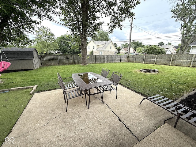 729 Maple Ln, Brownsburg, IN 46112 - fenced backyard featuring a patio area, a fire pit, a storage shed, and outdoor dining area