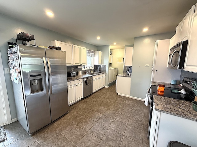 729 Maple Ln, Brownsburg, IN 46112 - kitchen with stainless steel appliances, white cabinets, recessed lighting, washer and clothes dryer, and dark tile patterned floors