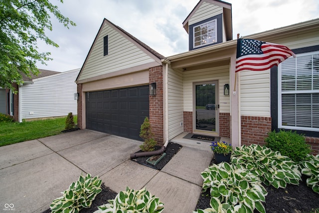 4238 Victory Ct, Indianapolis, IN 46203 - view of front of house featuring brick siding, driveway, and an attached garage