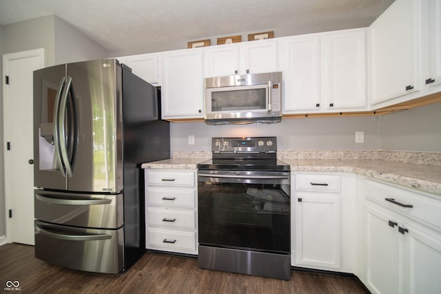 4238 Victory Ct, Indianapolis, IN 46203 - kitchen featuring stainless steel appliances, white cabinetry, dark wood-style floors, light stone counters, and a textured ceiling