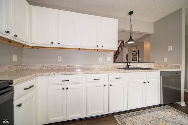4238 Victory Ct, Indianapolis, IN 46203 - kitchen featuring stainless steel dishwasher, stove, white cabinetry, dark wood-style floors, and decorative light fixtures