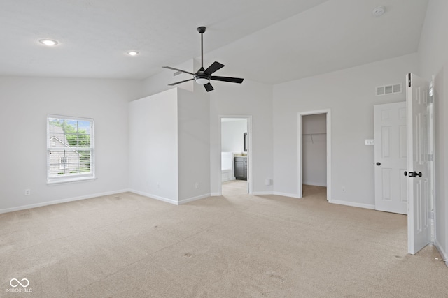 2078 Seneca Ln, Plainfield, IN 46168 - unfurnished bedroom with light colored carpet, a walk in closet, vaulted ceiling, ensuite bath, and recessed lighting
