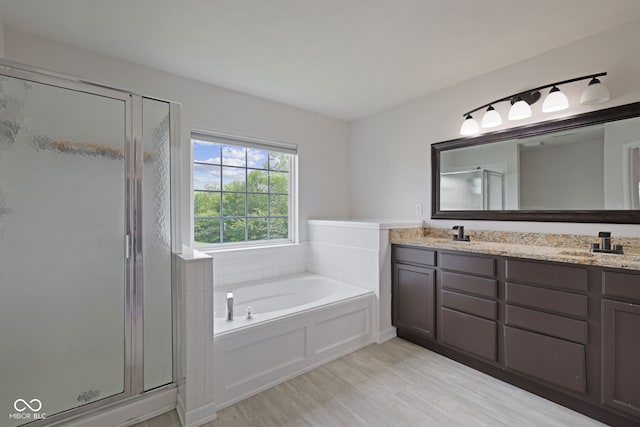 2078 Seneca Ln, Plainfield, IN 46168 - full bathroom with a stall shower, double vanity, a bath, and wood finished floors