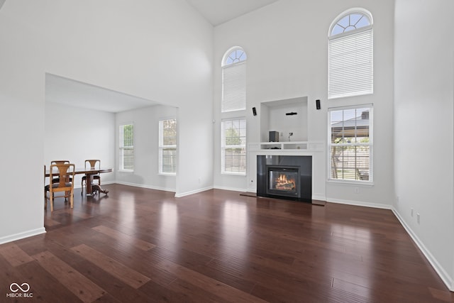2078 Seneca Ln, Plainfield, IN 46168 - living room featuring wood finished floors, a towering ceiling, and a tiled fireplace