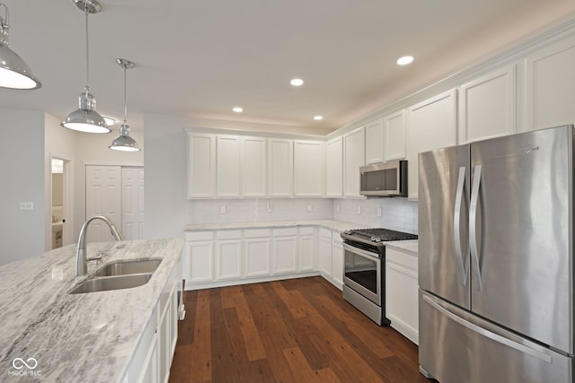 2078 Seneca Ln, Plainfield, IN 46168 - kitchen with stainless steel appliances, white cabinetry, tasteful backsplash, light stone counters, and dark wood-style flooring