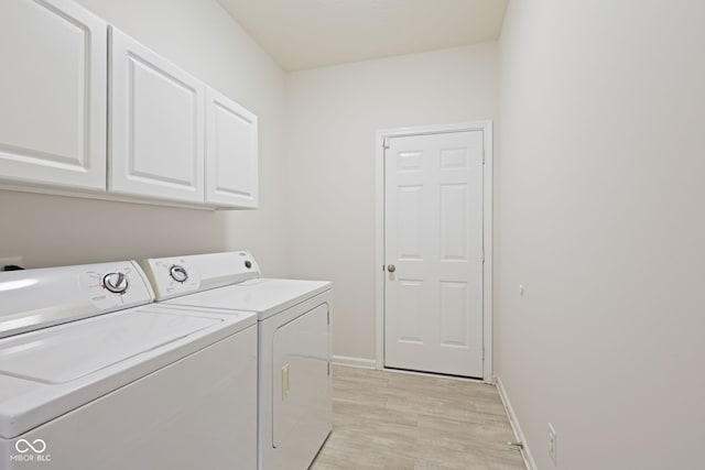 2078 Seneca Ln, Plainfield, IN 46168 - washroom with cabinet space, independent washer and dryer, and light wood-style flooring