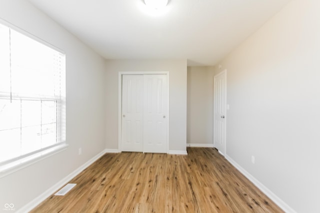 413 Youngs Creek Ct, Franklin, IN 46131 - unfurnished bedroom with a closet and light wood finished floors