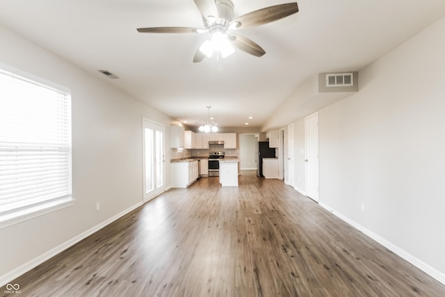 413 Youngs Creek Ct, Franklin, IN 46131 - unfurnished living room with a chandelier, wood finished floors, and ceiling fan