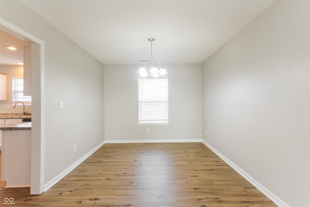 413 Youngs Creek Ct, Franklin, IN 46131 - unfurnished dining area with light wood-type flooring and a chandelier