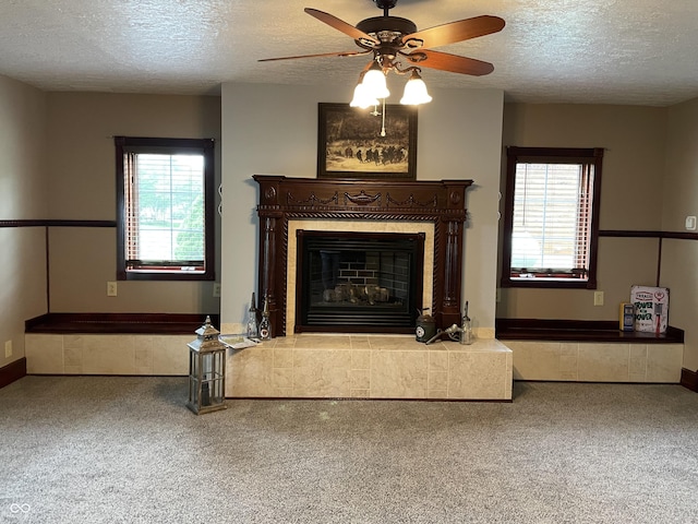 14380 N 300 E, Covington, IN 47932 - carpeted living area with a textured ceiling, plenty of natural light, ceiling fan, and a tiled fireplace