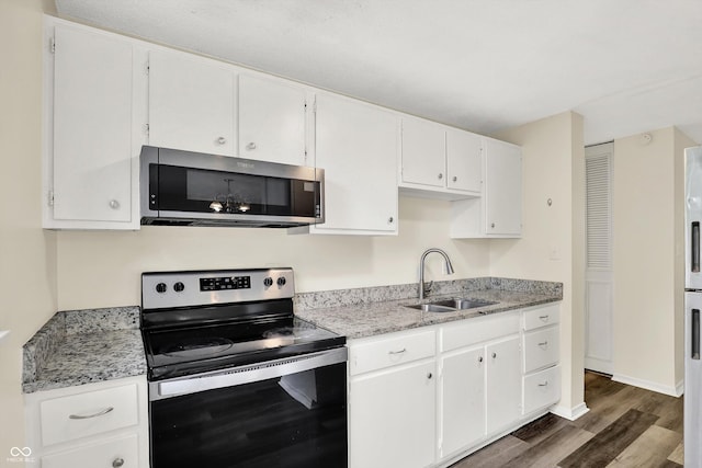 8920 Caminito Rd, Indianapolis, IN 46234 - kitchen featuring stainless steel appliances, dark wood-style floors, white cabinetry, and light stone counters