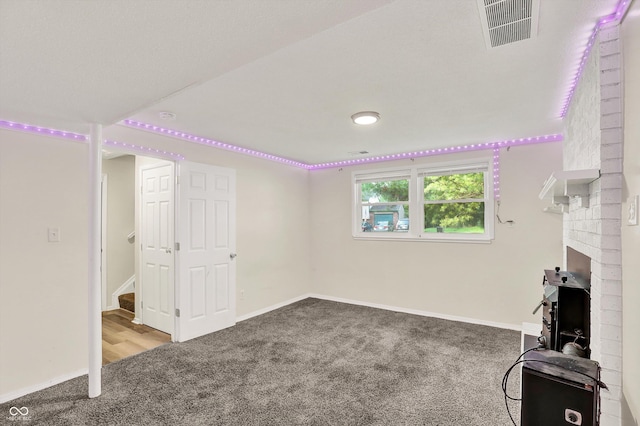 8920 Caminito Rd, Indianapolis, IN 46234 - below grade area featuring carpet, stairs, and a fireplace