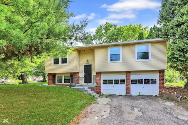 8920 Caminito Rd, Indianapolis, IN 46234 - bi-level home with brick siding, a garage, driveway, and a front lawn