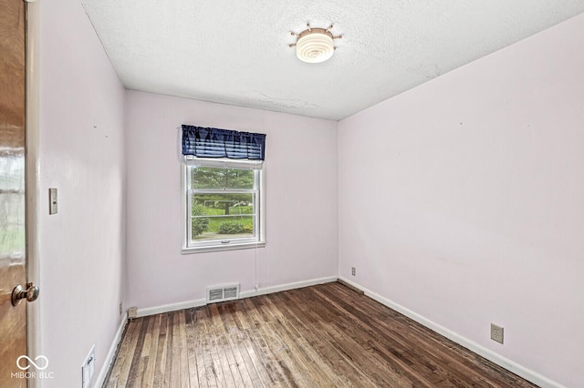 4010 S Bazil Ave, Indianapolis, IN 46239 - empty room with hardwood / wood-style floors and a textured ceiling