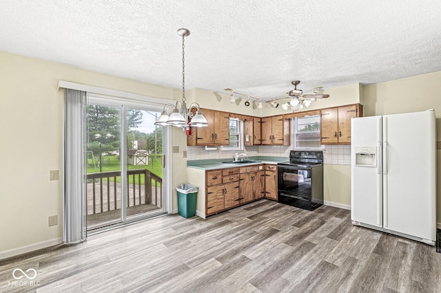 4010 S Bazil Ave, Indianapolis, IN 46239 - kitchen featuring white fridge with ice dispenser, electric range, brown cabinets, light wood finished floors, and light countertops
