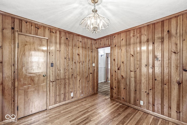 4010 S Bazil Ave, Indianapolis, IN 46239 - unfurnished room with a chandelier, wood finished floors, and wooden walls