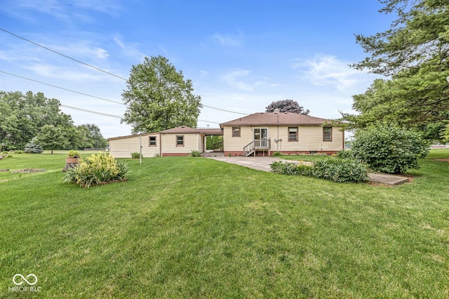 4010 S Bazil Ave, Indianapolis, IN 46239 - rear view of property featuring a yard
