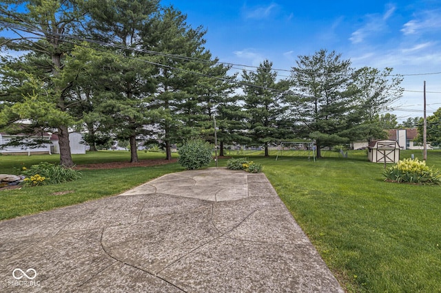 4010 S Bazil Ave, Indianapolis, IN 46239 - view of green lawn featuring a storage unit and a patio