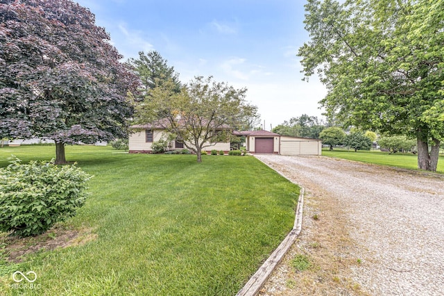 4010 S Bazil Ave, Indianapolis, IN 46239 - view of front of house with a front yard, an outdoor structure, and a detached garage