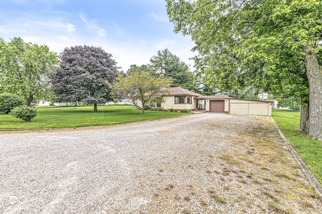 4010 S Bazil Ave, Indianapolis, IN 46239 - view of front of house with gravel driveway, a front lawn, an outbuilding, and a garage