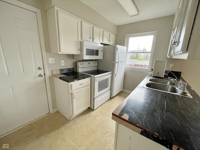 5667 Broyles Rd, Avon, IN 46123 - kitchen with white appliances, white cabinetry, and dark countertops
