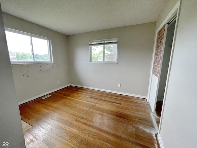 5667 Broyles Rd, Avon, IN 46123 - unfurnished bedroom with wood finished floors, a textured ceiling, and a closet