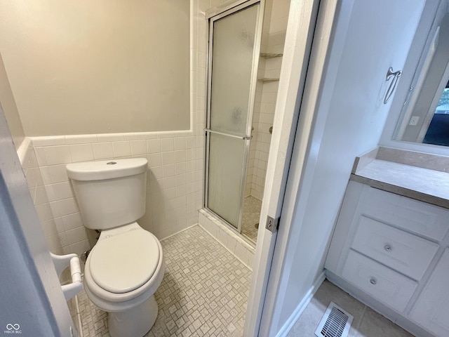 5667 Broyles Rd, Avon, IN 46123 - bathroom with a stall shower, a wainscoted wall, vanity, tile walls, and tile patterned flooring